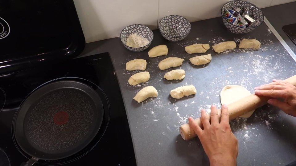 Division de la pâte en portions pour préparer les naans au fromage.