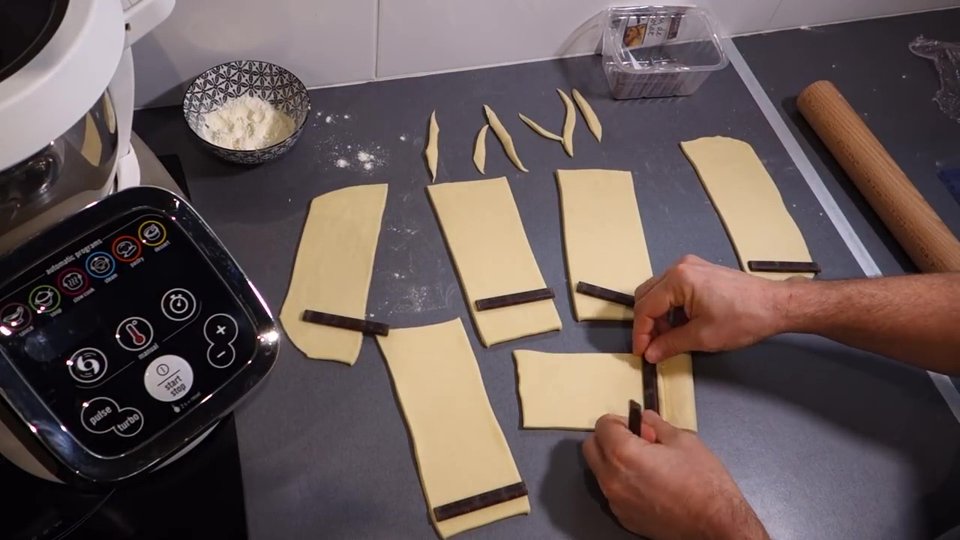 Façonnage des pains au chocolat avec barres de chocolat.